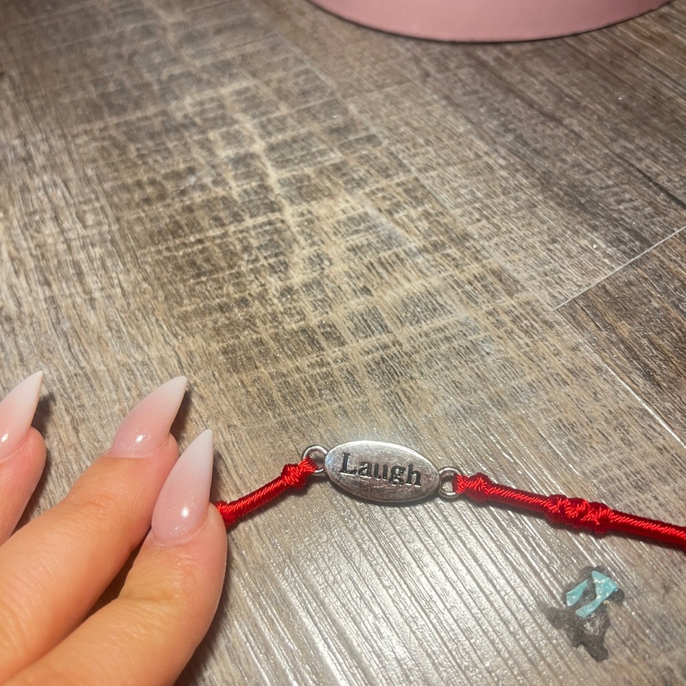 Red String Bracelet with Silver 'Laugh' Charm